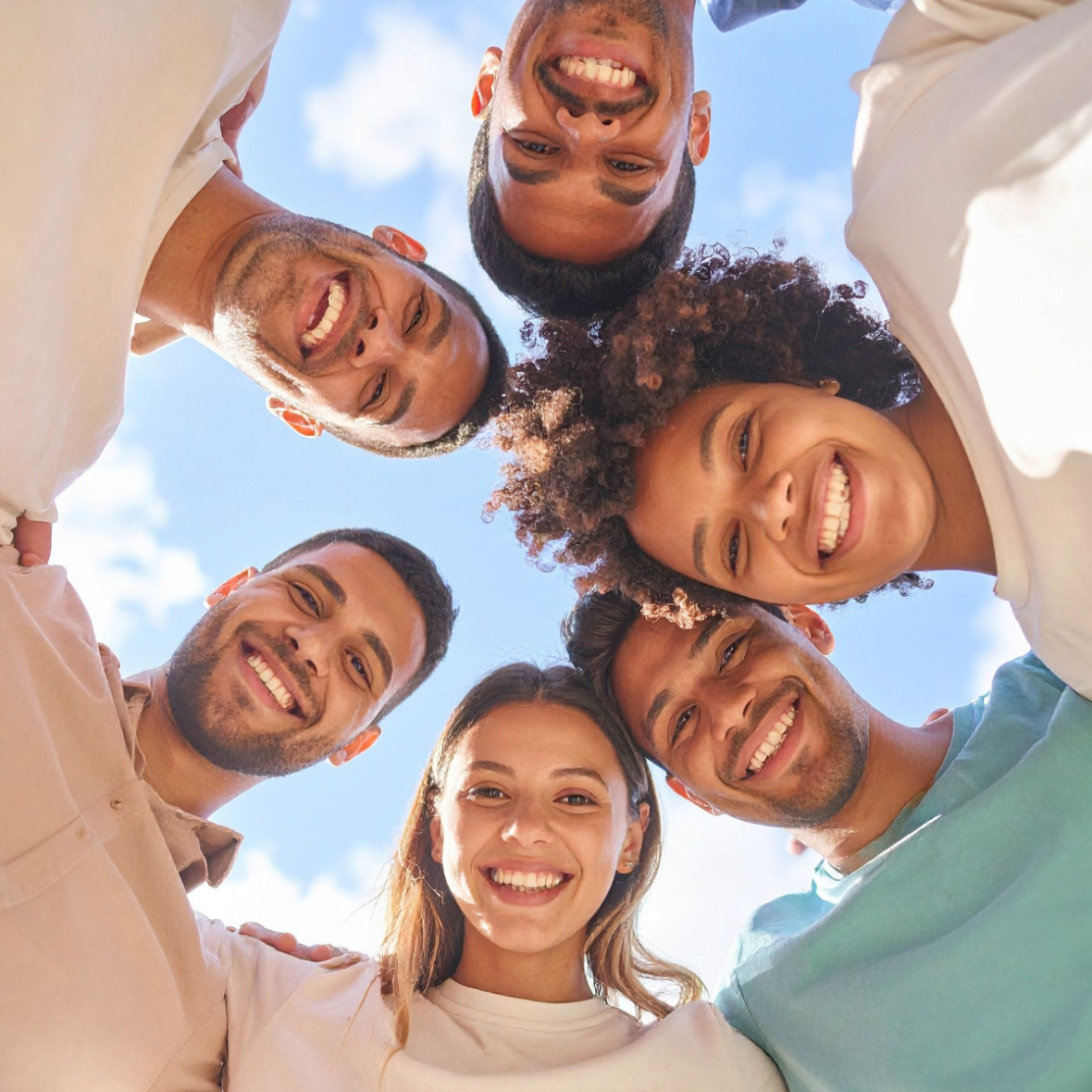 friends huddling around and smiling at the camera