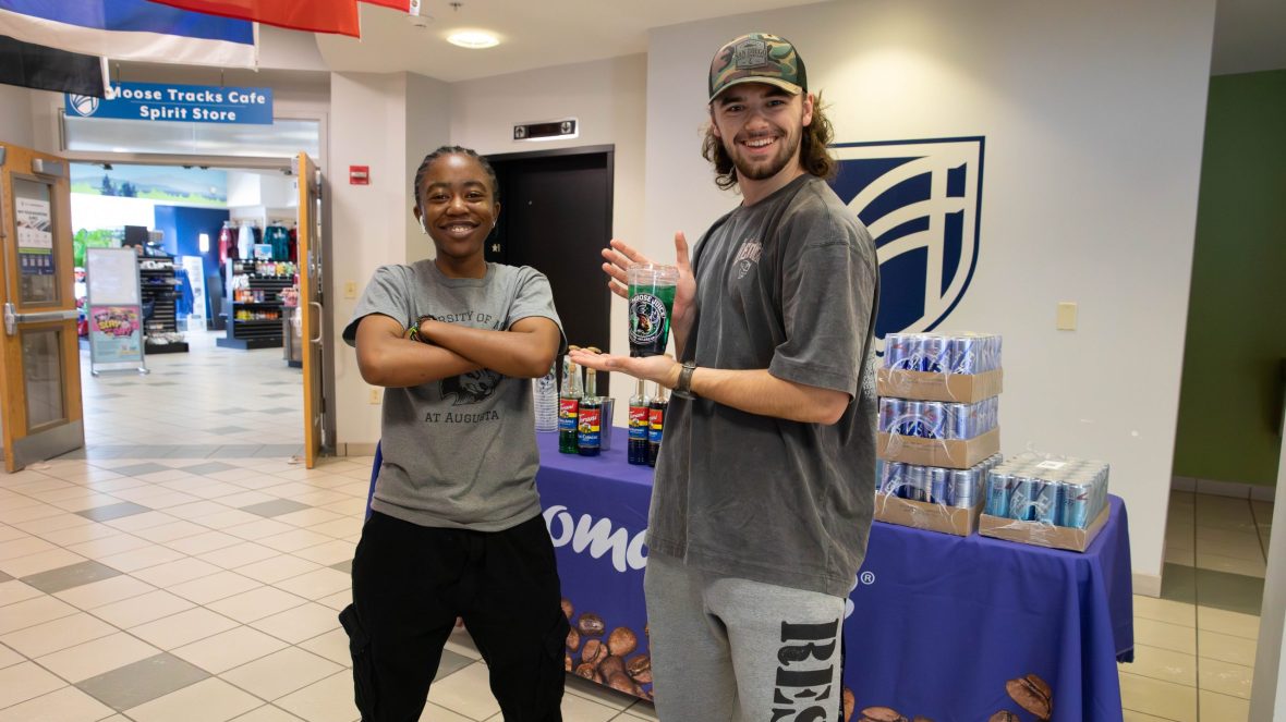 UMA students Bubbles and Aiden showing off Moose Juice