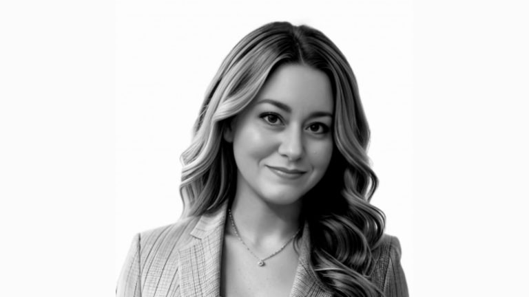 Black-and-white headshot of Leigh Alley, assistant professor and coordinator of teacher education at the University of Maine at Augusta, smiling and facing the camera.