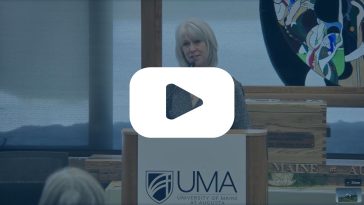 Frame from the Lunch and Learn Live stream with an overlay of a "Play" button