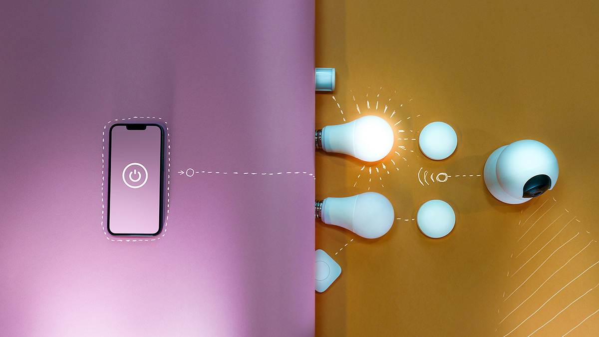 A smartphone with a power button icon on its screen sits on a pink background, visually connected by dotted lines to smart home devices on a yellow background, including light bulbs, round sensors, and a security camera, illustrating phone-controlled home automation.