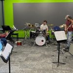 Rock and jazz ensemble rehearsing in the studio