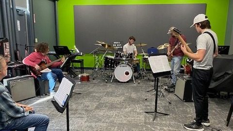Rock and jazz ensemble rehearsing in the studio
