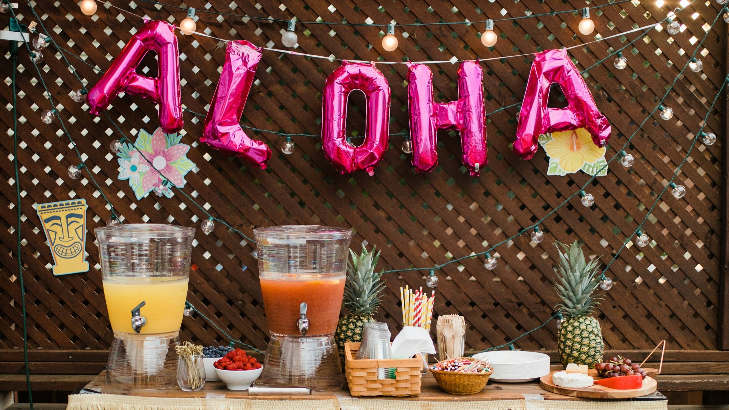 A table with refreshments, with balloons spelling out "ALOHA"