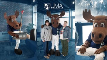 Composite image featuring UMA’s moose mascot inside a bright campus lounge. Left: the mascot playfully lifts a metal pail with a red shovel. Center: the mascot stands with two smiling adults, one in a UMA sweatshirt. Top center reads “UMA Counseling & Wellness.” Right: close-up of the mascot seated, with frosted window artwork behind.