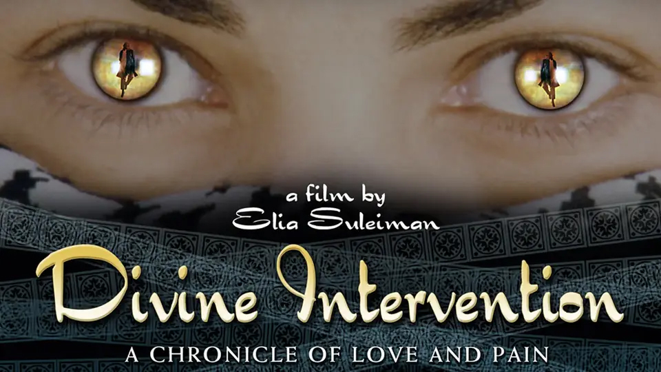 Alt text: Close-up of a person’s eyes framed by a patterned scarf, with small silhouetted figures reflected in each pupil. Text reads “a film by Elia Suleiman” and “Divine Intervention: A Chronicle of Love and Pain.”
