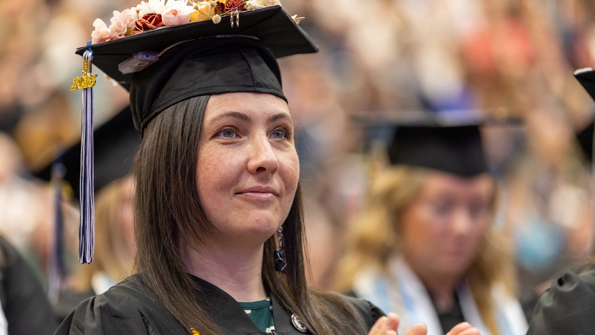 UMA Graduating student in cap and gown
