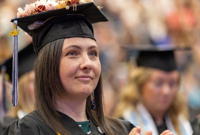 UMA Graduating student in cap and gown