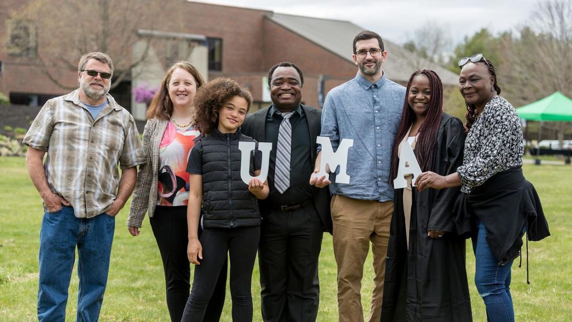 A family poses for a group photo outside after the 2024 Commencement ceremony