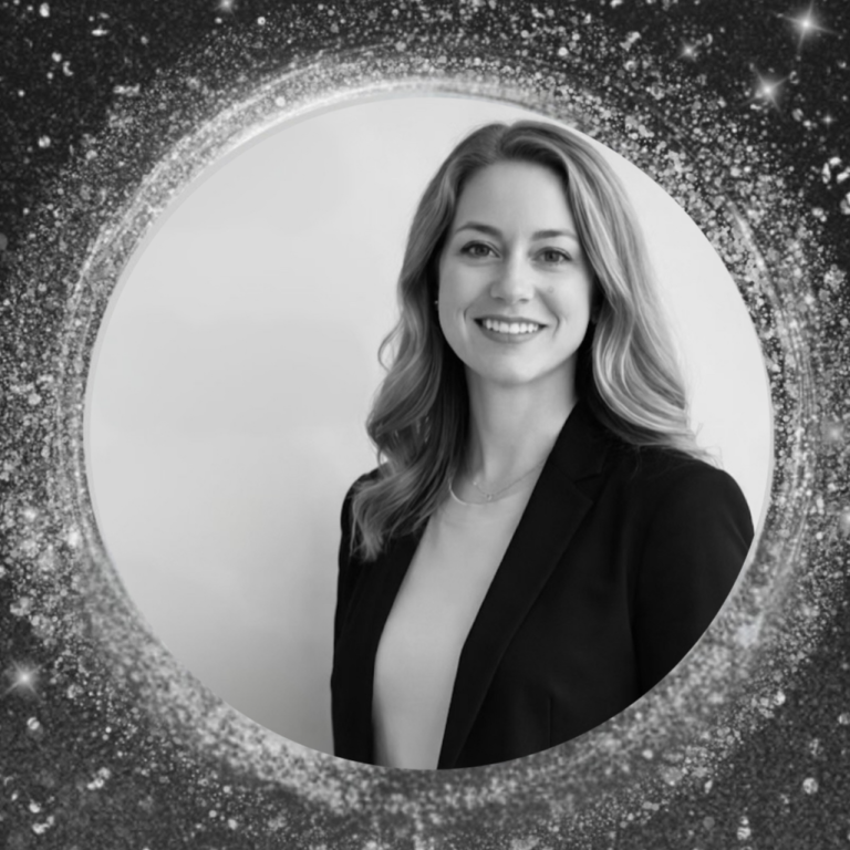 A smiling woman with long hair and wearing a blazer is framed within a circle of star-like points of light.