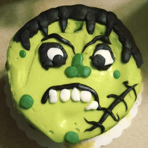 Cake decorated with green, black, and white fondant to resemble Frankenstein's head/face.