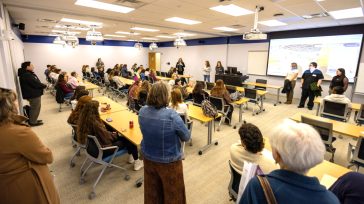 High school students sit in a UMA classroom while faculty and staff present information during a Medical Bootcamp health care career exploration event.