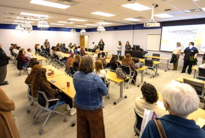 High school students sit in a UMA classroom while faculty and staff present information during a Medical Bootcamp health care career exploration event.