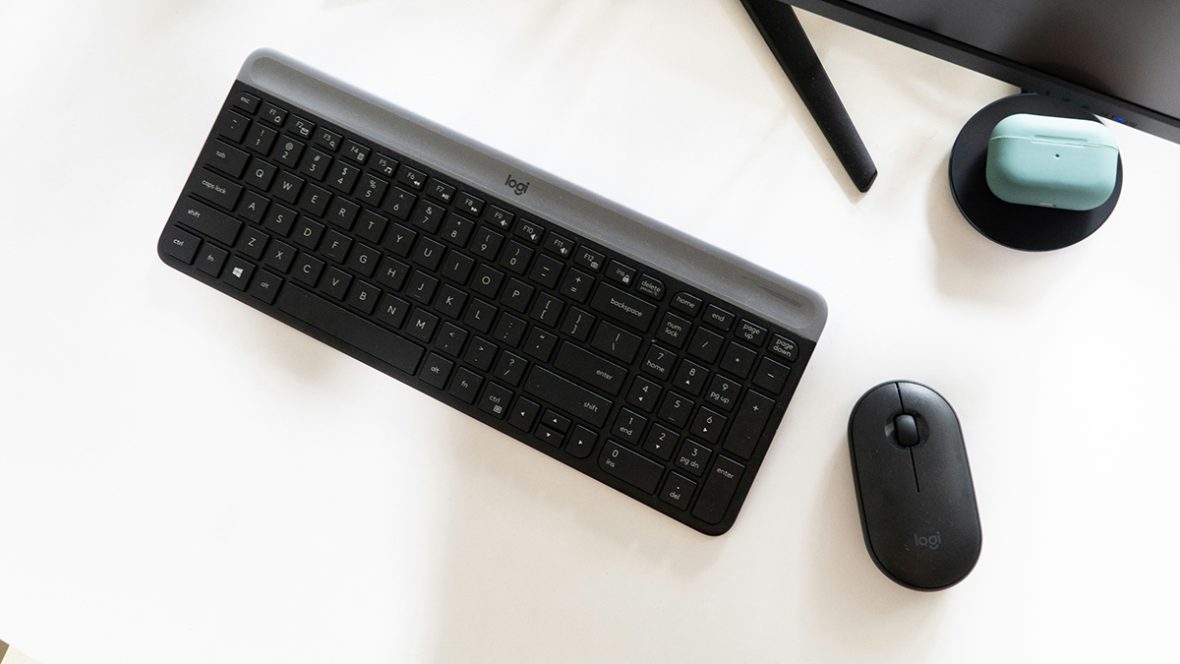 A logitech keyboard and mouse on a desk.
