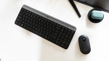 A logitech keyboard and mouse on a desk.