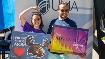 Employees Liz and Duncan at last year's Accepted Student Day photo booth
