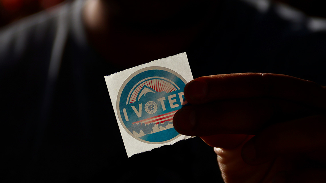 "I voted" sticker held up in the light