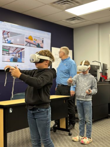 Kids in Aviation Day participants exploring aircraft via Virtual Reality headsets