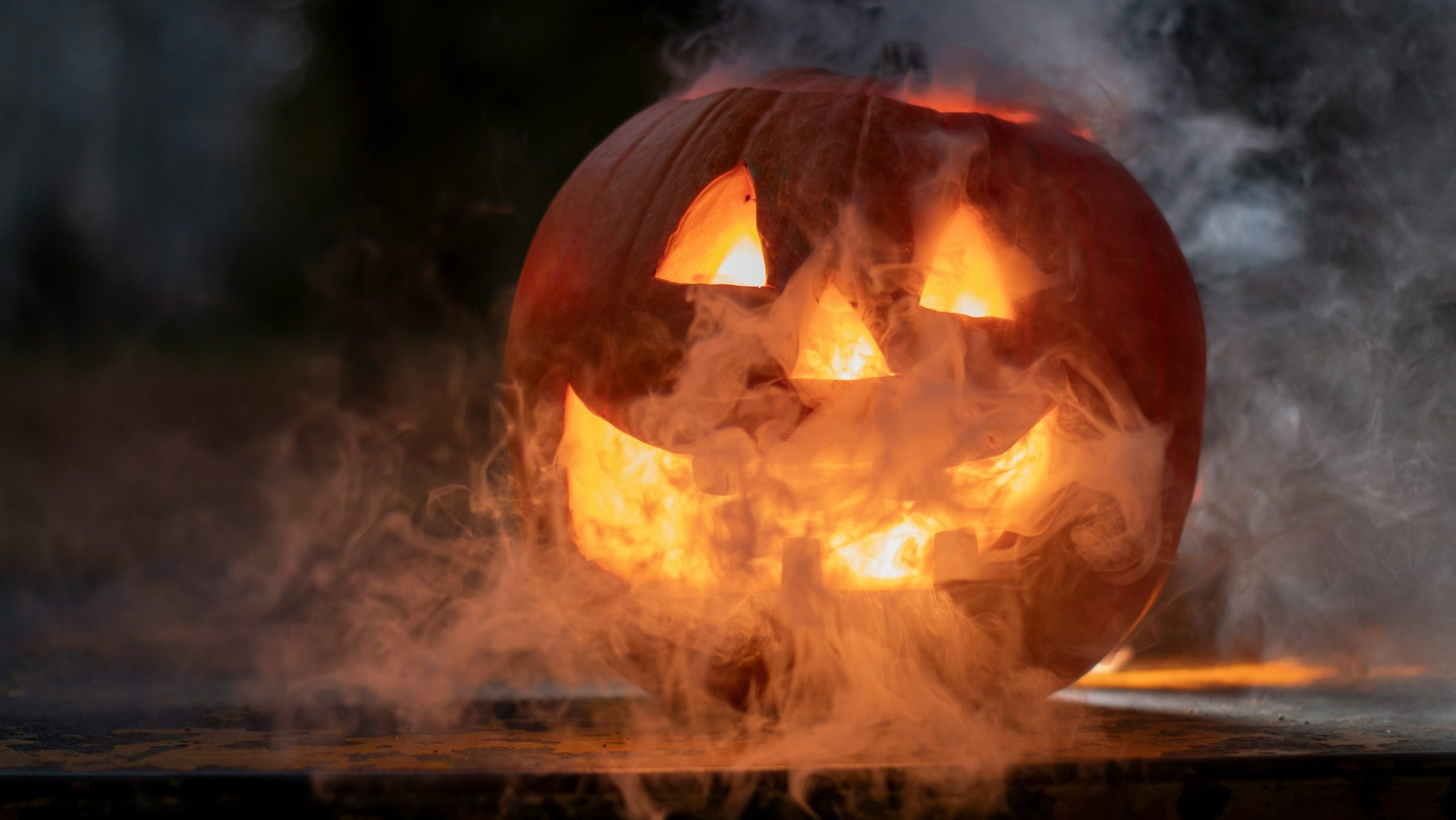 A spooky jack-o-lantern glowing with smoke